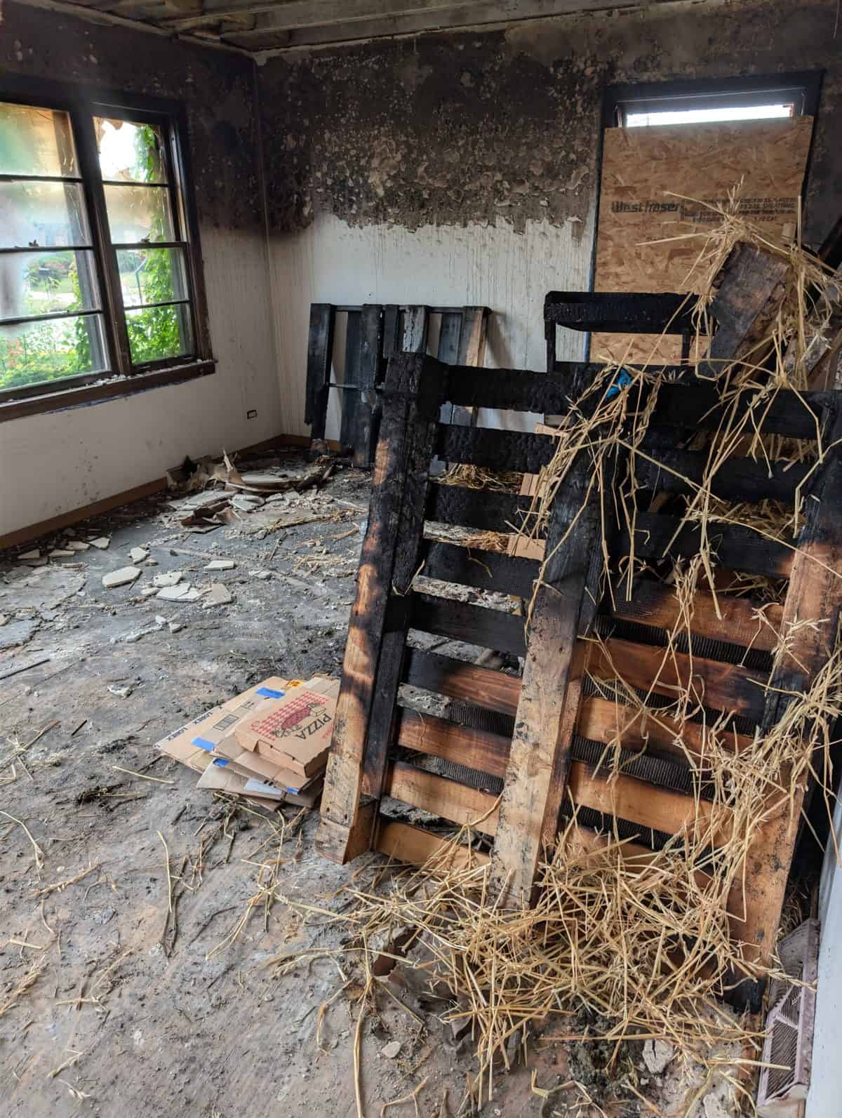 Wooden pallets, straw and cardboard stacked in the living room